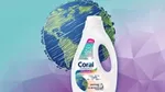 Bottle of Coral Color+, laundry liquid created using carbon captured from industrial emissions, in front of image of world